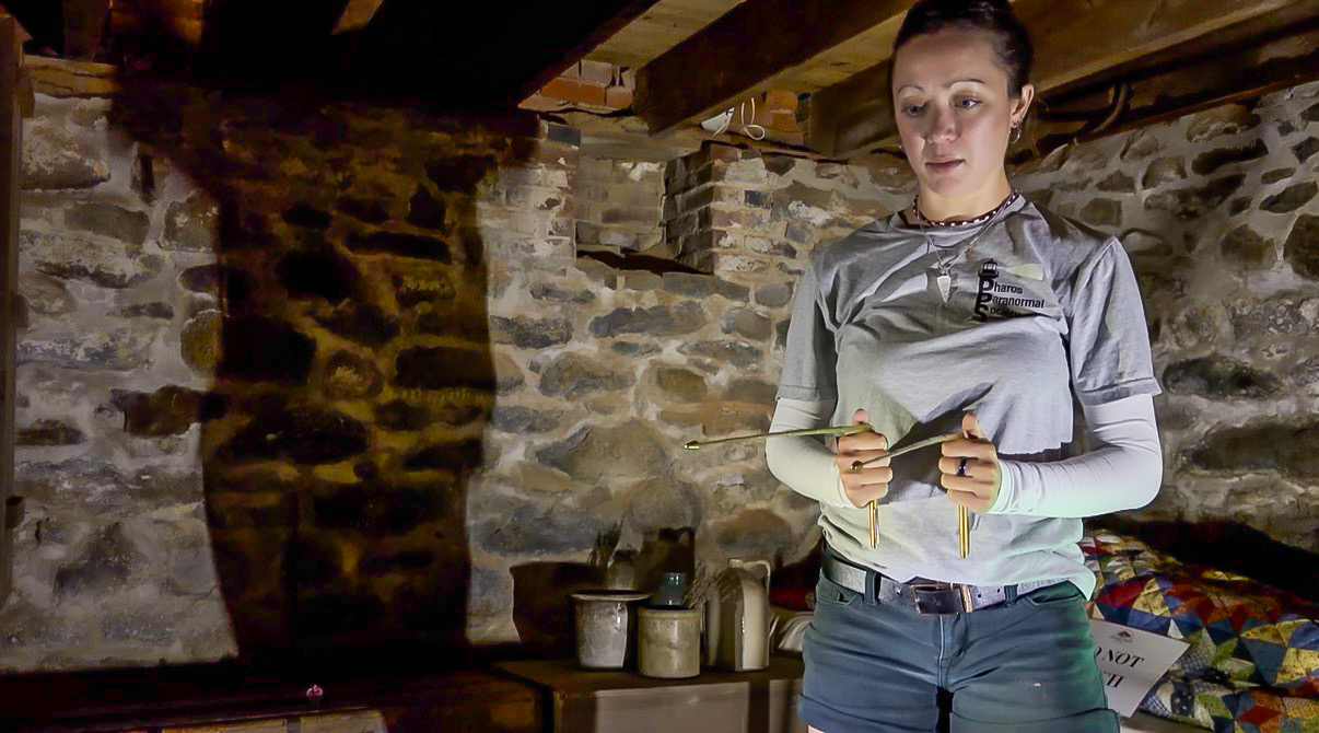 Pharos Paranormal Society team member working with investigation equipment