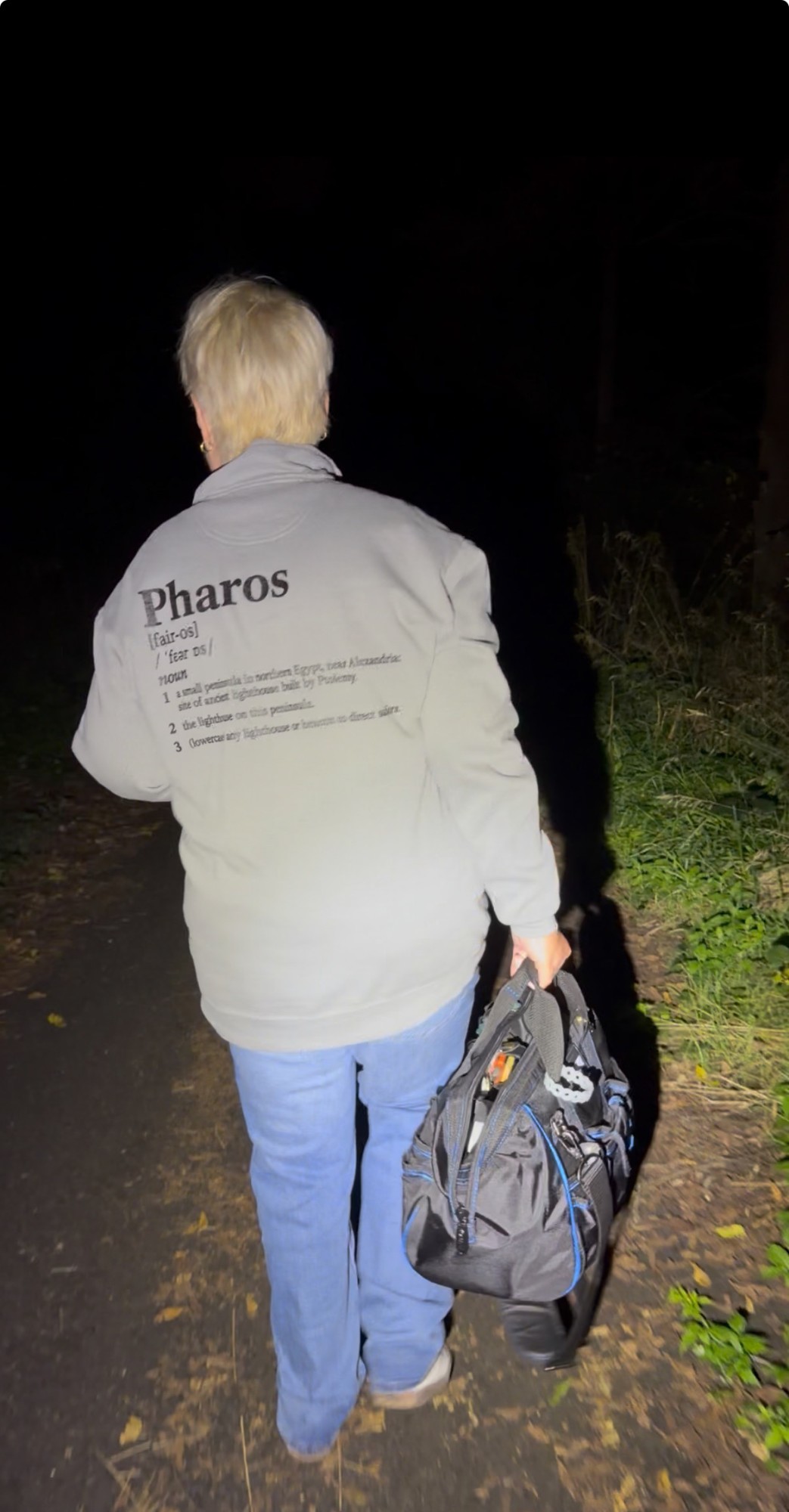 Pharos Paranormal Society team member working with investigation equipment
